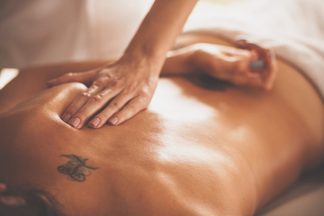 Woman receiving deep tissue massage at spa